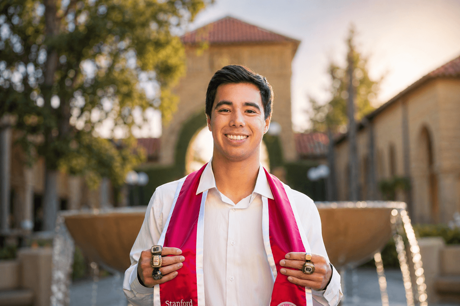 Jeremy Bischoff at Stanford holding NCAA championship rings